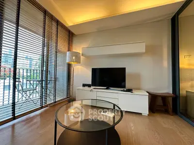 Modern living room with sleek TV setup and large windows offering city views.