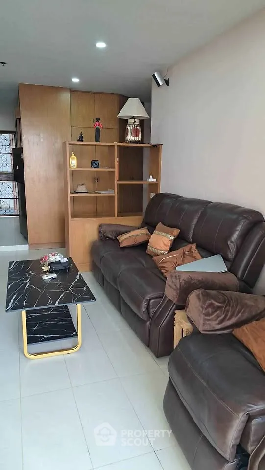 Stylish living room with leather sofas and modern decor in a cozy apartment.