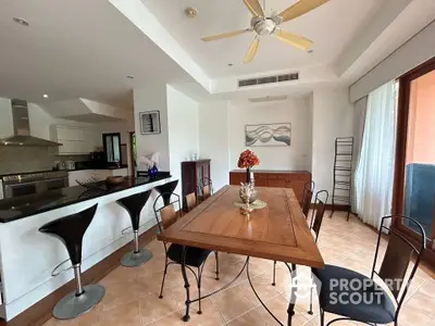 Spacious open-plan kitchen and dining area with modern decor and natural light