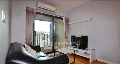 Cozy living room with balcony access and modern furnishings