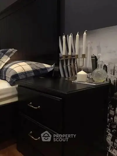 Stylish bedroom with elegant nightstand and decorative candles