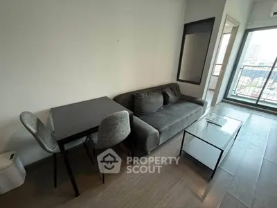Modern living room with sleek furniture and city view balcony