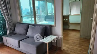 Modern apartment interior with cozy living room and city view balcony.