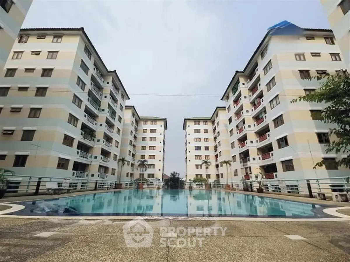 Spacious residential complex with a central swimming pool and modern architecture.