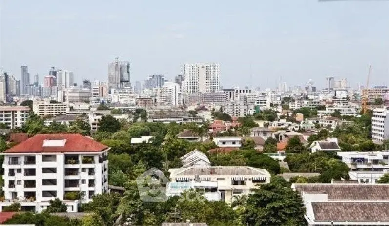 Stunning cityscape view showcasing urban skyline and lush greenery, perfect for real estate investment.