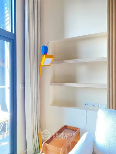 Modern living room with bright natural light and stylish shelving