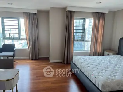 Spacious bedroom with city view and elegant hardwood flooring