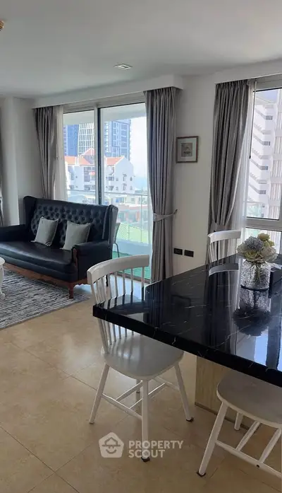 Stylish living room with modern furniture and city view, perfect for urban living.