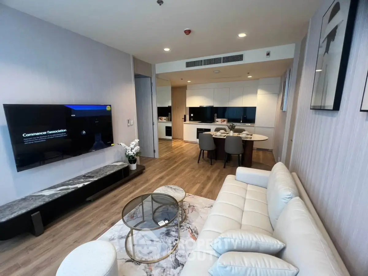 Modern open-layout living room with sleek kitchen and stylish decor