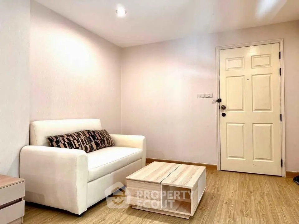 Cozy living room with modern sofa and wooden coffee table, perfect for relaxation.