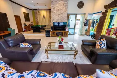 Spacious living room with elegant decor and pool table, perfect for entertaining.