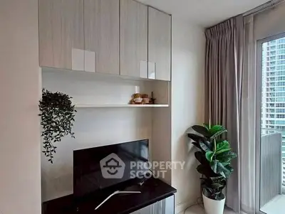 Modern living room with sleek TV setup and balcony view