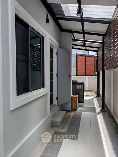 Modern exterior corridor with sleek design and natural light, featuring a stylish covered walkway.