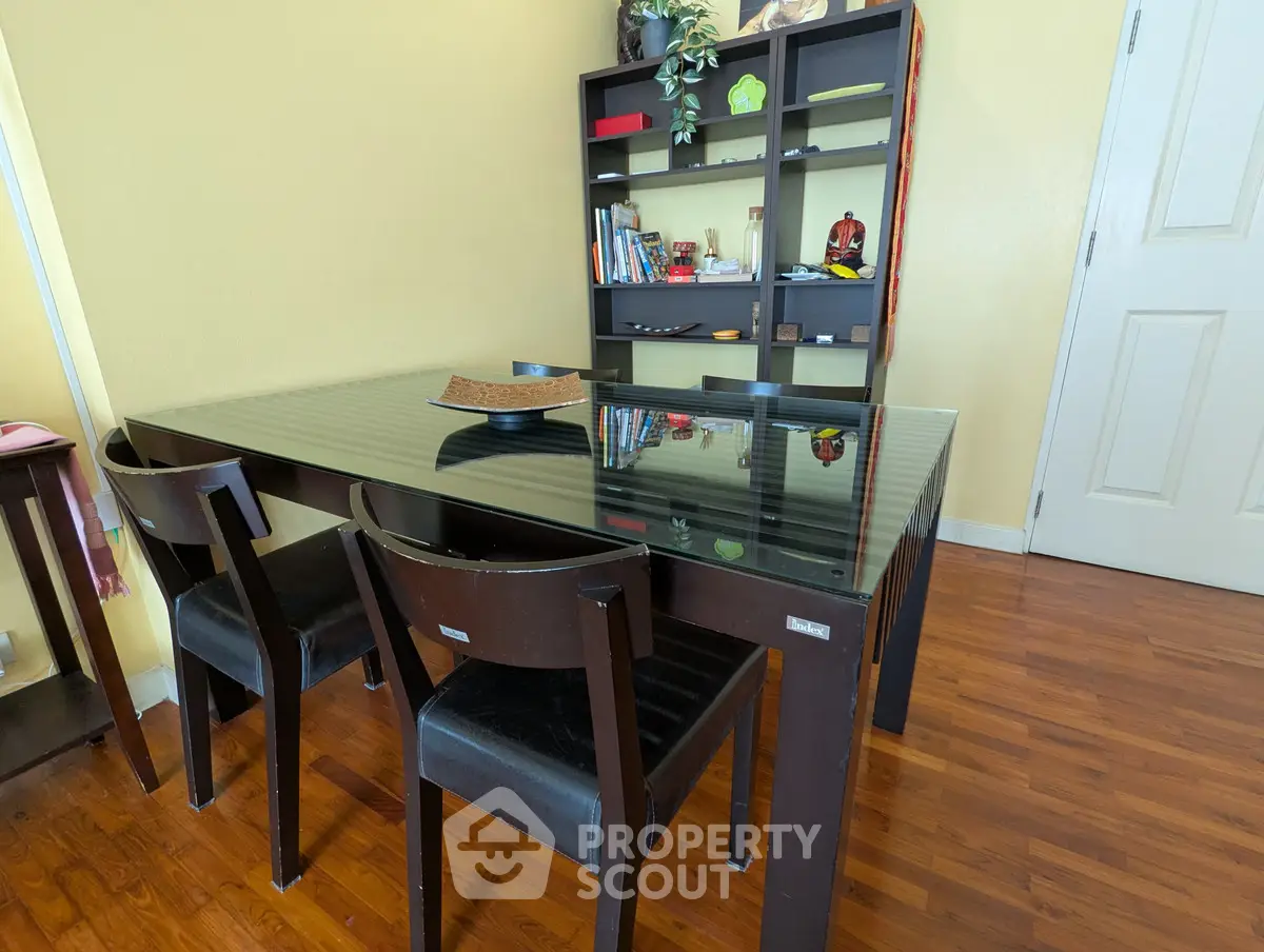 Chic dining area with glass-top table and modern chairs, perfect for stylish home gatherings.