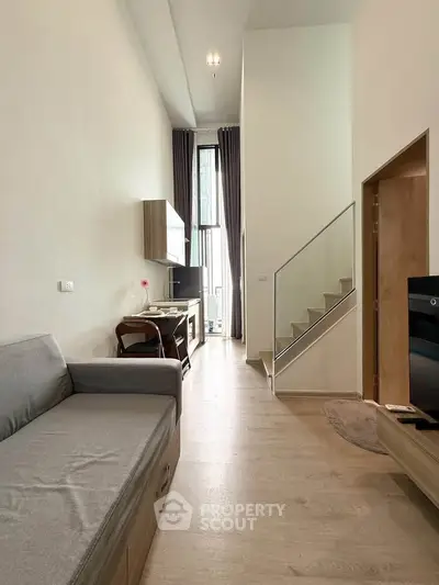 Modern living room with high ceilings and staircase in stylish apartment
