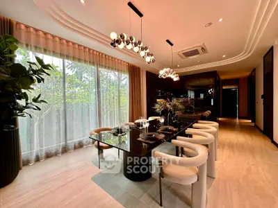 Luxurious dining room with elegant lighting and modern decor, featuring a large window with garden view.