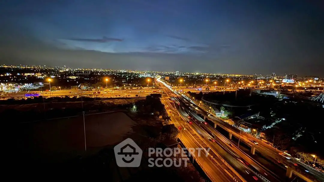 Stunning cityscape view with vibrant night lights and busy highways.