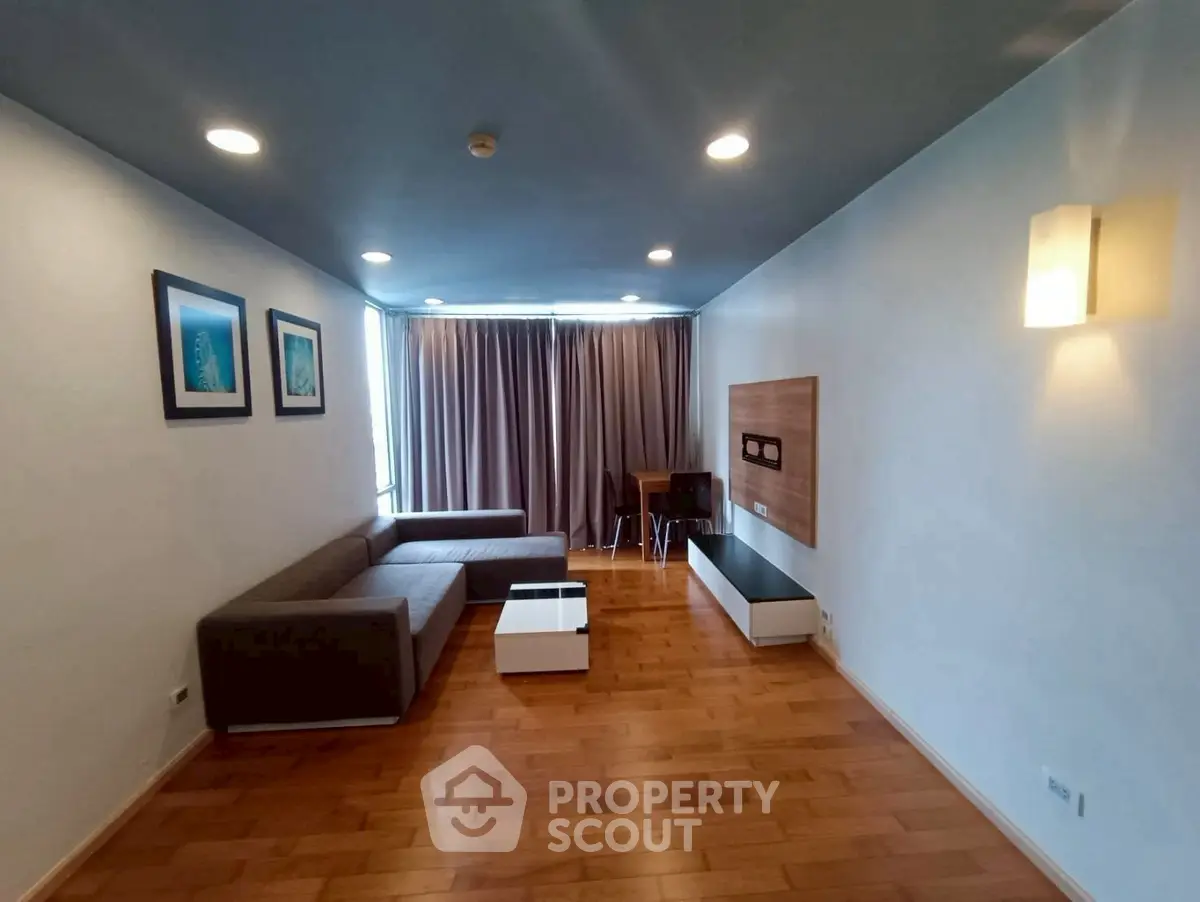 Spacious modern living room with wooden flooring and stylish furniture