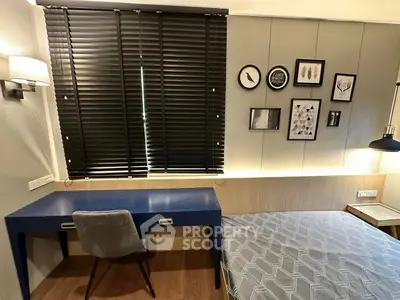 Modern bedroom with stylish decor and workspace, featuring a sleek desk and comfortable chair.