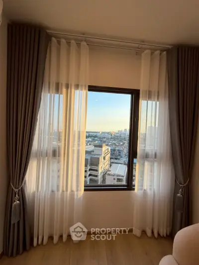 Stunning city view from a modern apartment window with elegant curtains
