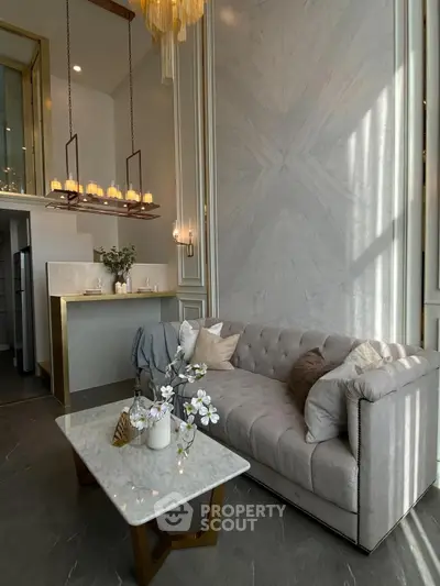 Luxurious living room with elegant marble accents and plush sofa