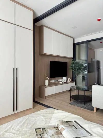 Modern living room with sleek furniture and built-in TV unit, showcasing contemporary design.