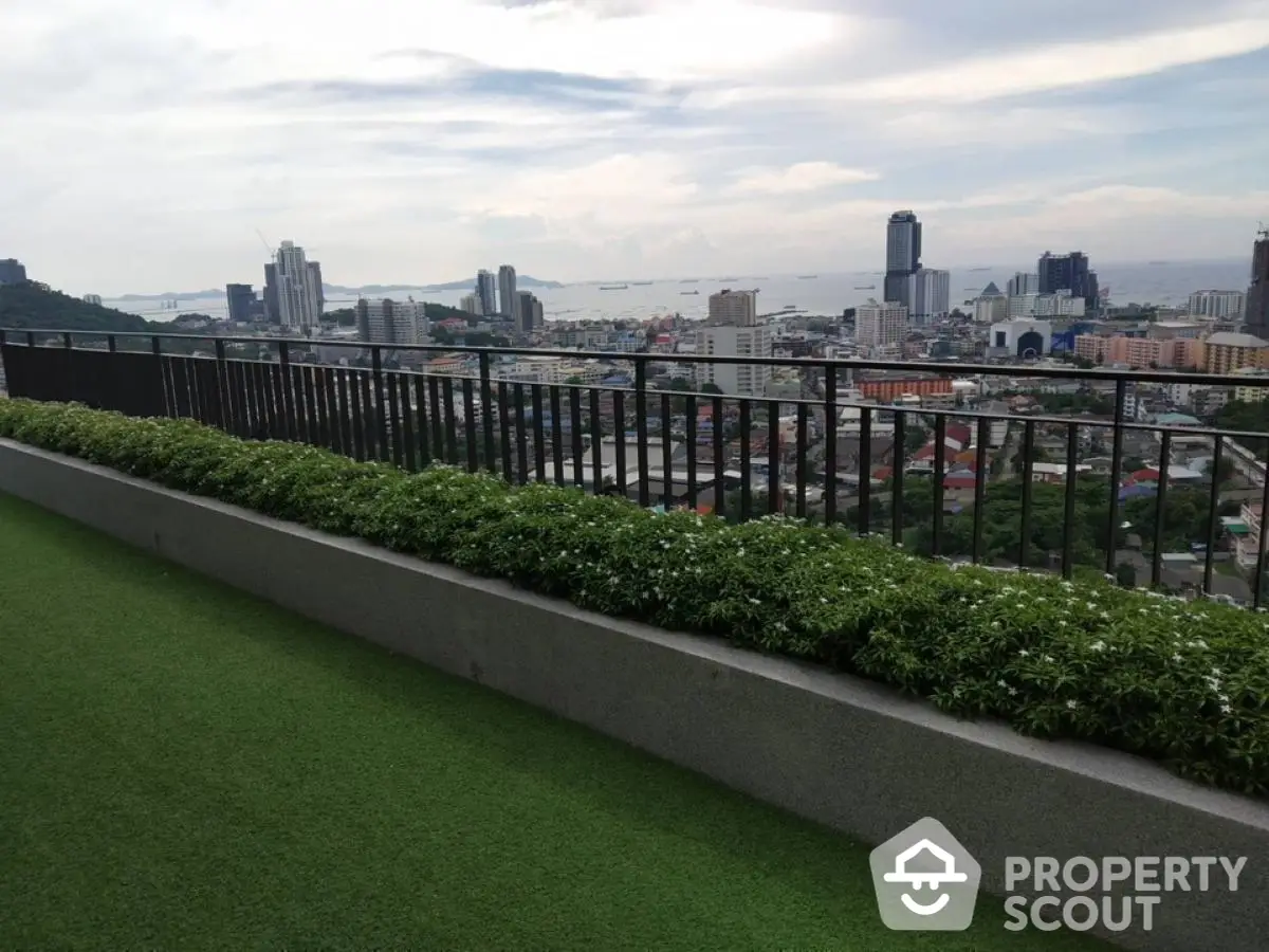 Stunning cityscape view from a lush green rooftop garden, perfect for relaxation and entertainment.