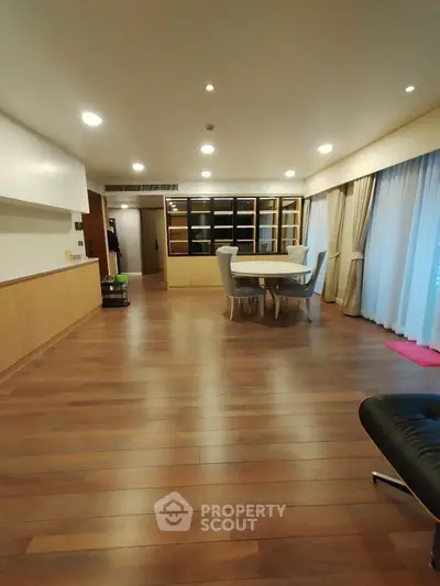 Spacious modern living room with wooden flooring and elegant dining area