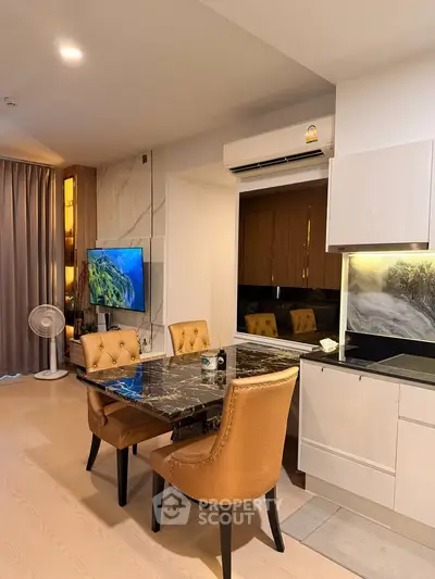 Modern dining area with marble table and stylish chairs in a contemporary apartment.