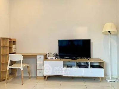 Modern living room with sleek TV stand, desk, and stylish lamp in minimalist design.