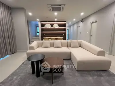 Spacious modern living room with elegant sectional sofa and stylish decor