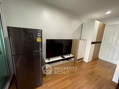 Modern apartment interior with sleek appliances and wooden flooring
