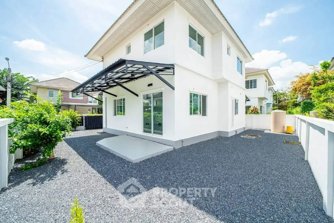 Modern two-story house with sleek design and spacious outdoor area in a serene neighborhood.