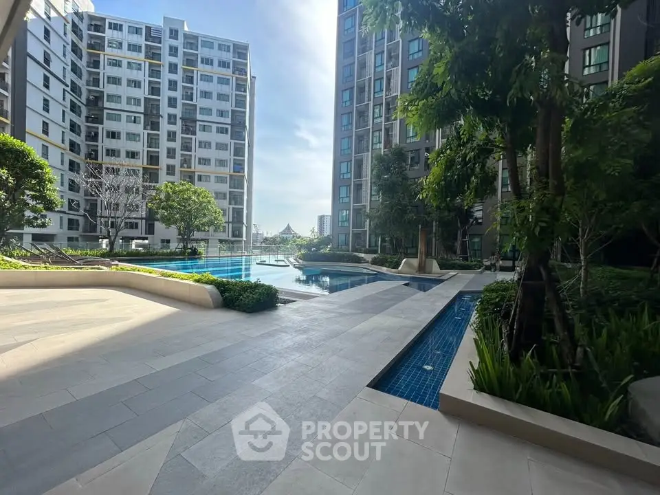 Luxurious condominium with stunning pool and lush greenery in urban setting