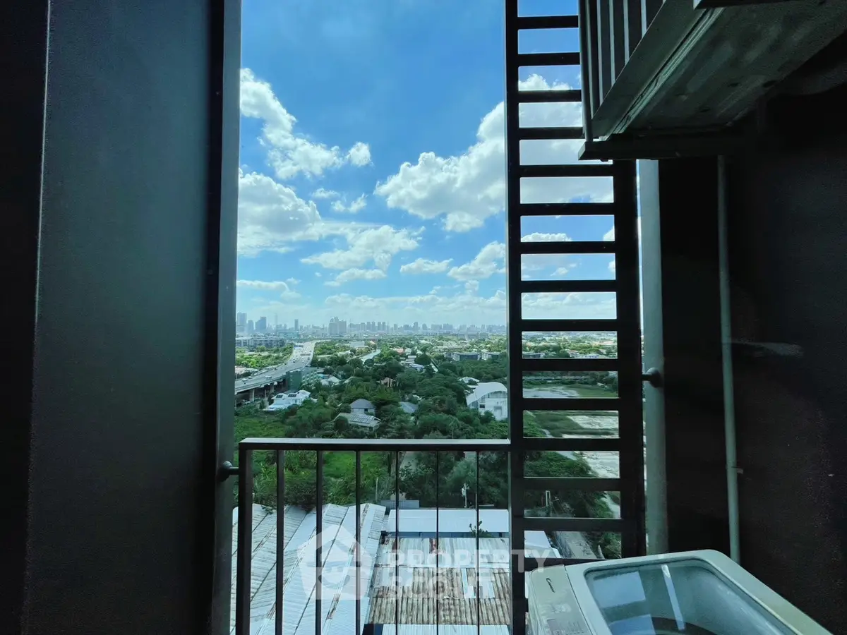 Stunning high-rise balcony view overlooking lush greenery and city skyline, perfect for urban living.