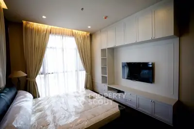 Luxurious bedroom with built-in storage and large window for natural light