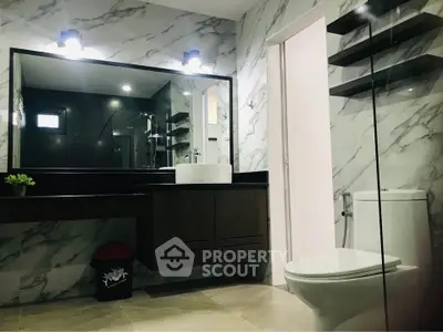 Luxurious modern bathroom with marble walls and sleek fixtures