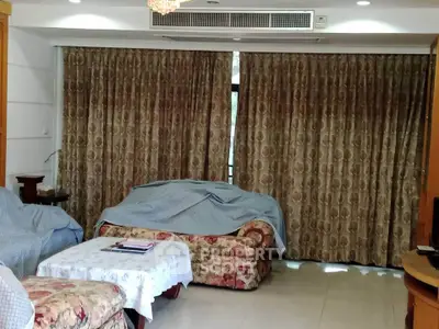 Spacious living room with elegant curtains and comfortable seating in a cozy home setting.