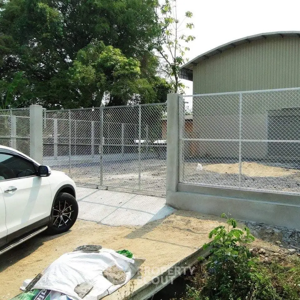 Spacious industrial property with secure fencing and ample parking space.