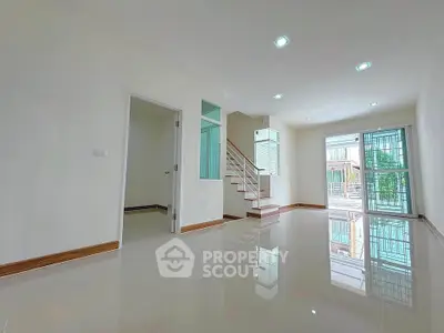 Spacious modern living room with glossy floors and large windows