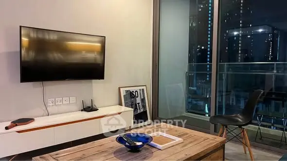 Modern living room with city view, sleek furniture, and wall-mounted TV, perfect for urban living.