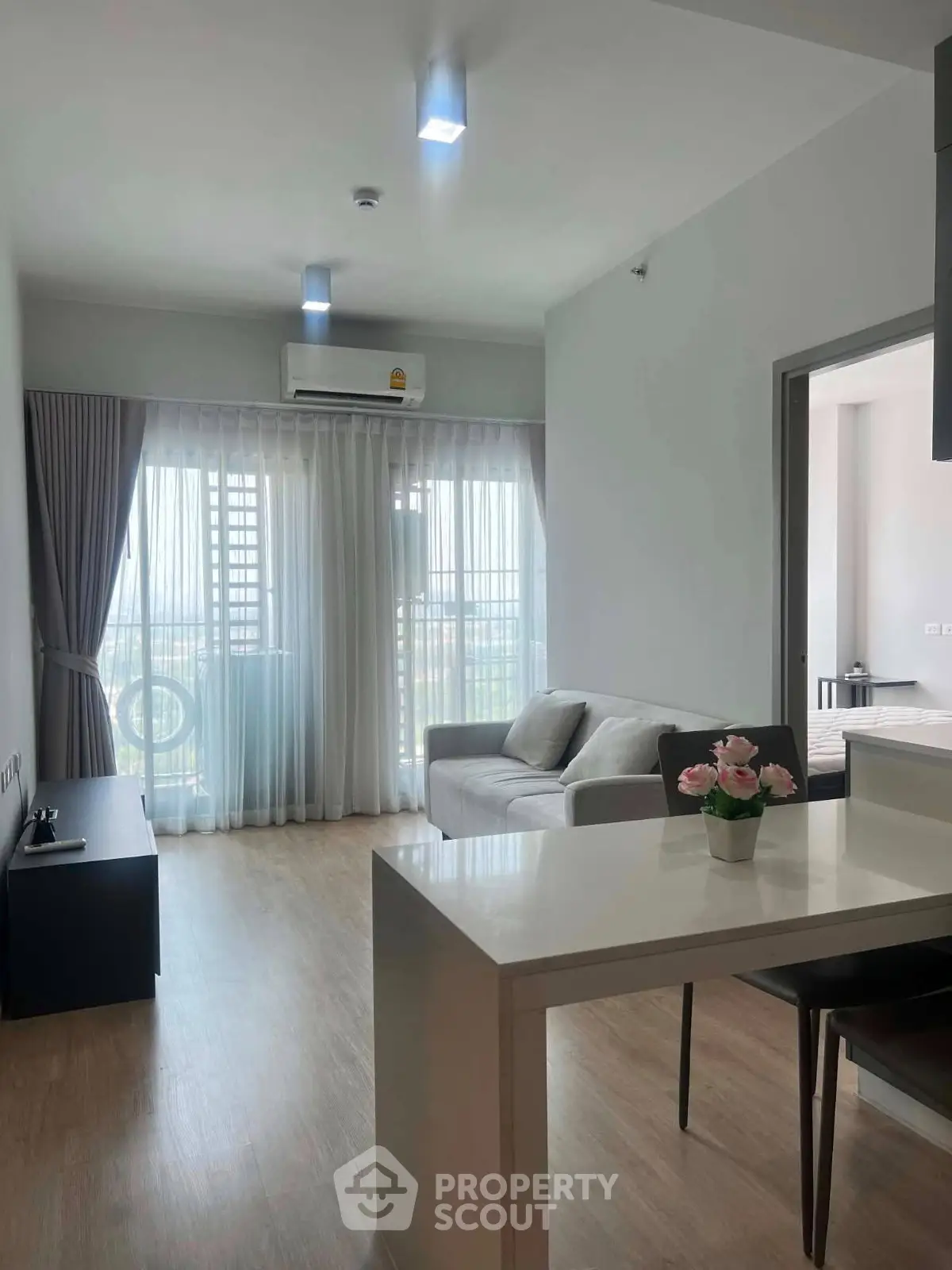 Modern living room with natural light, sleek furniture, and open layout in a stylish apartment.