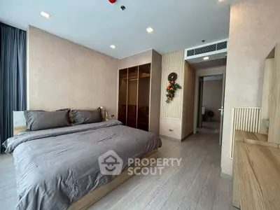 Spacious modern bedroom with elegant decor and ample natural light