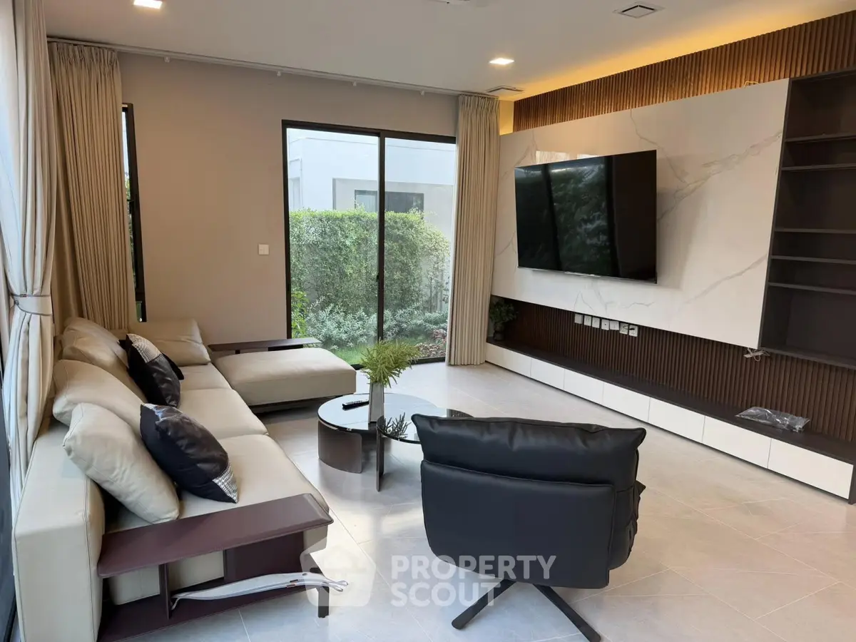 Luxurious modern living room with sleek furniture and garden view, perfect for relaxation and entertainment.