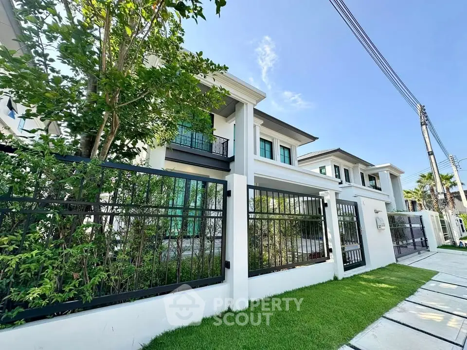 Luxurious modern house with lush garden and elegant facade in a serene neighborhood.
