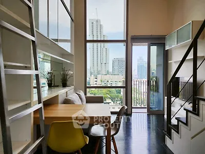 Modern loft apartment with city view, high ceilings, and stylish interior design.
