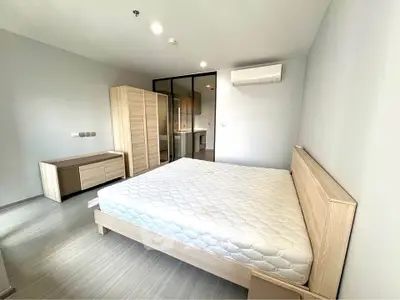 Spacious modern bedroom with minimalist design and ample natural light