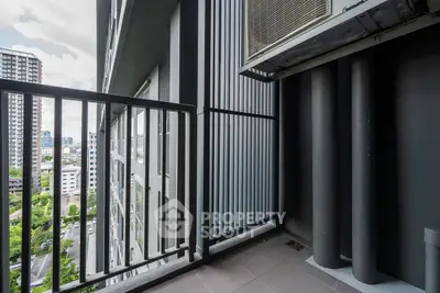 Modern apartment balcony with city view and sleek metal railing