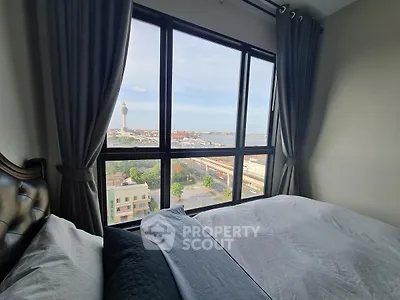 Stunning bedroom with panoramic city and sea view from large window.