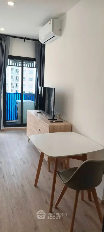 Modern living room with stylish decor and large windows for natural light.